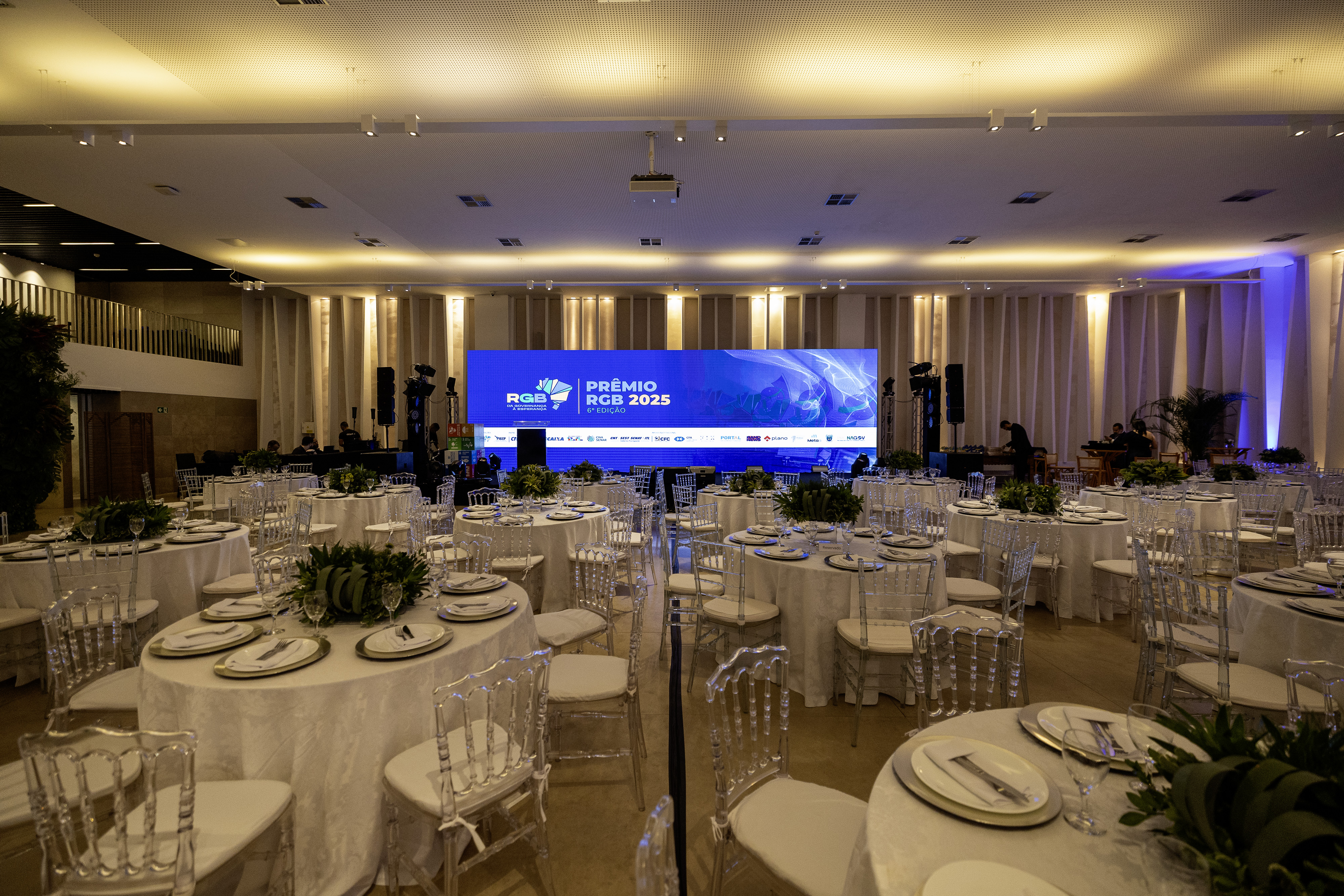 Cerim&ocirc;nia de gala com mesas postas e ilumina&ccedil;&atilde;o